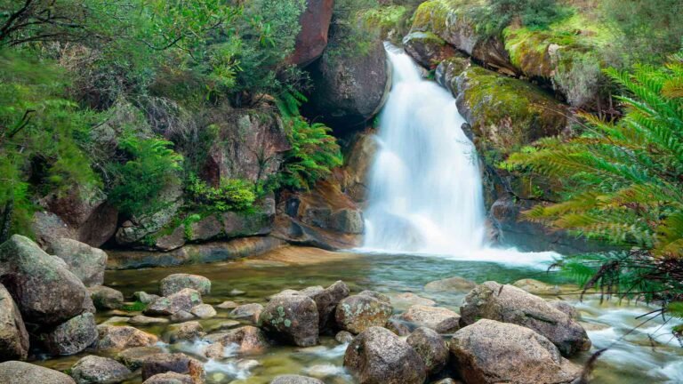 beautiful-shot-waterfall-flowing-near-lots-rocks