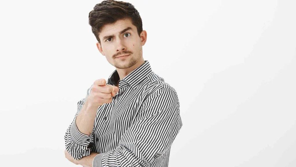 portrait-confident-joyful-male-enterpreneour-with-moustache-pointing-lifting-eyebrow-inviting-person-go-bar-together-aproving-good-point-view