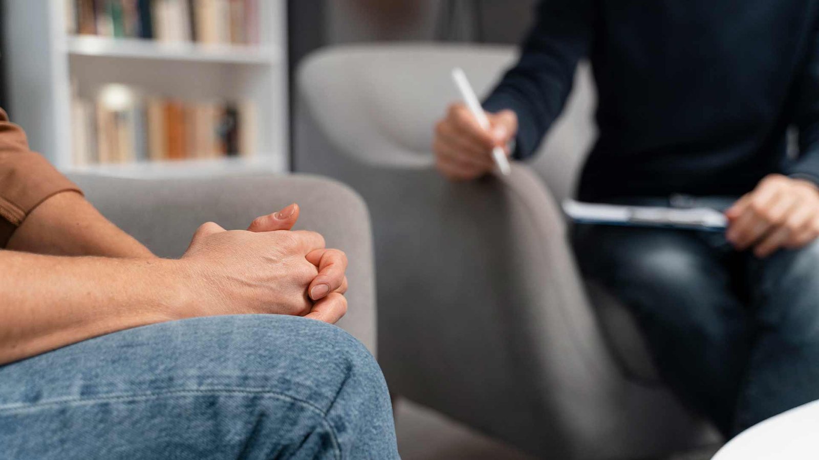 woman-with-hands-together-talking-with-counselor