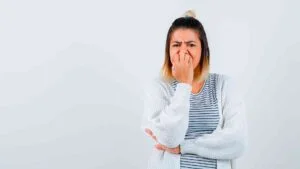 portrait-cute-lady-biting-nails-emotionally-t-shirt-cardigan-looking-anxious-front-view