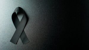 top-view-black-bow-as-mourning-symbol-dark-wall