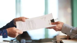 closeup-hands-passing-contract-unrecognizable-businessman