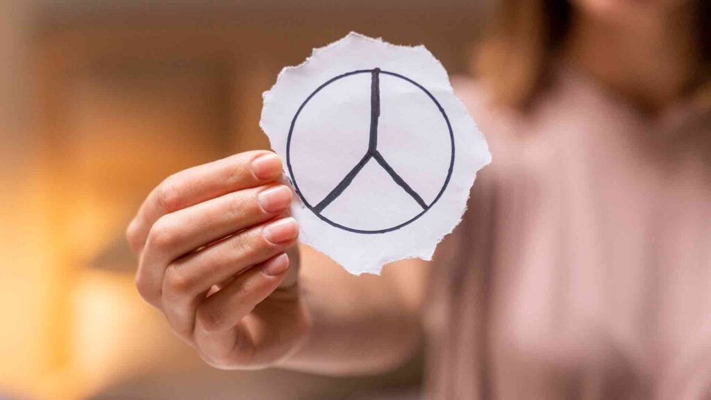 close-up-woman-holding-peace-sign