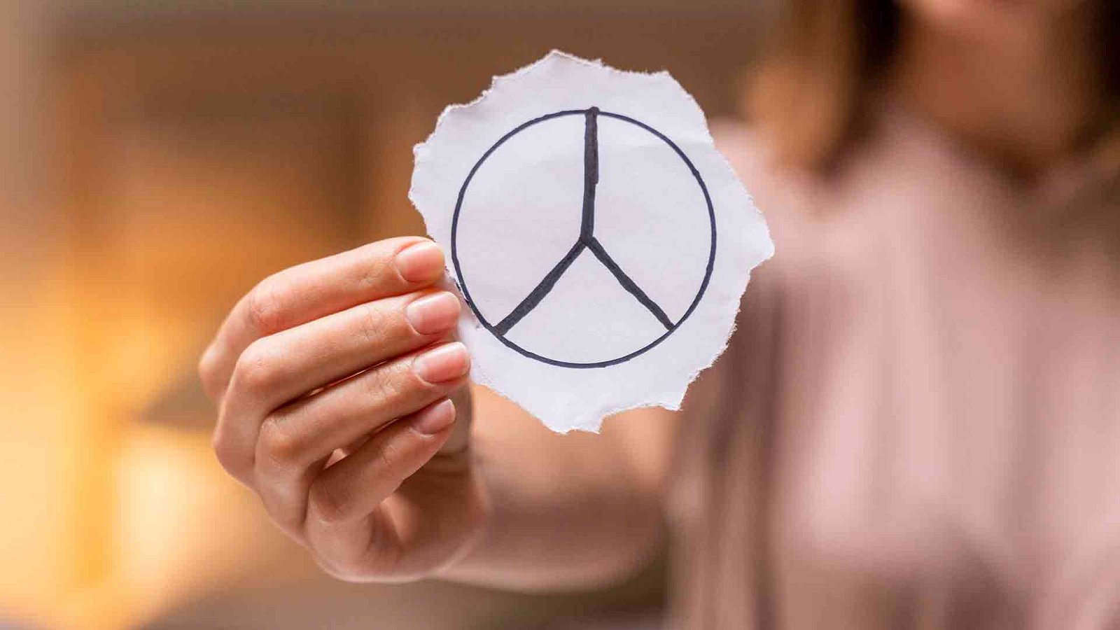 close-up-woman-holding-peace-sign