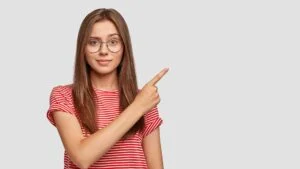 positive-glad-female-indicates-blank-copy-space-promotional-content