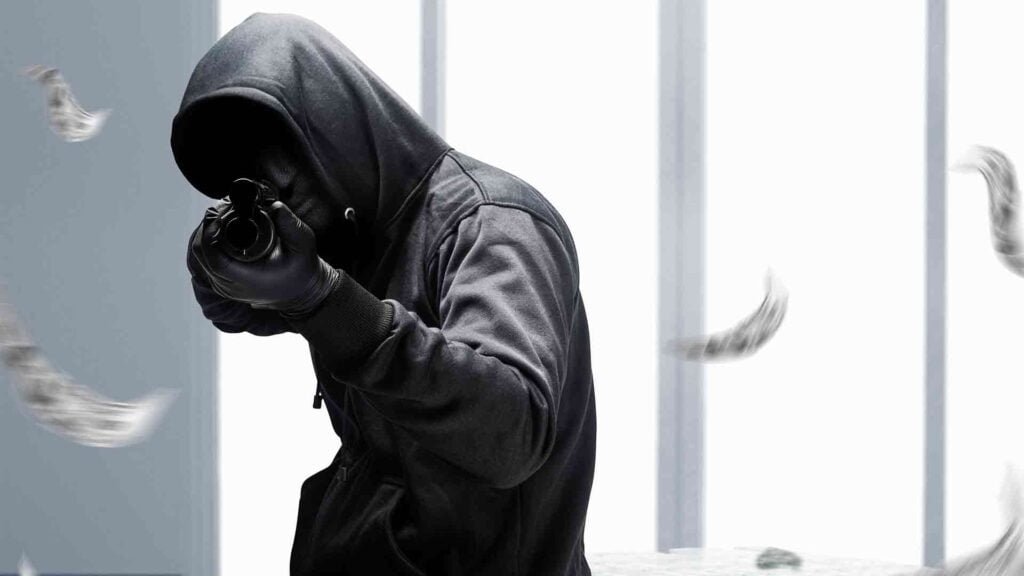 criminal-man-hidden-mask-pointing-shotgun-while-robbery-money-bank
