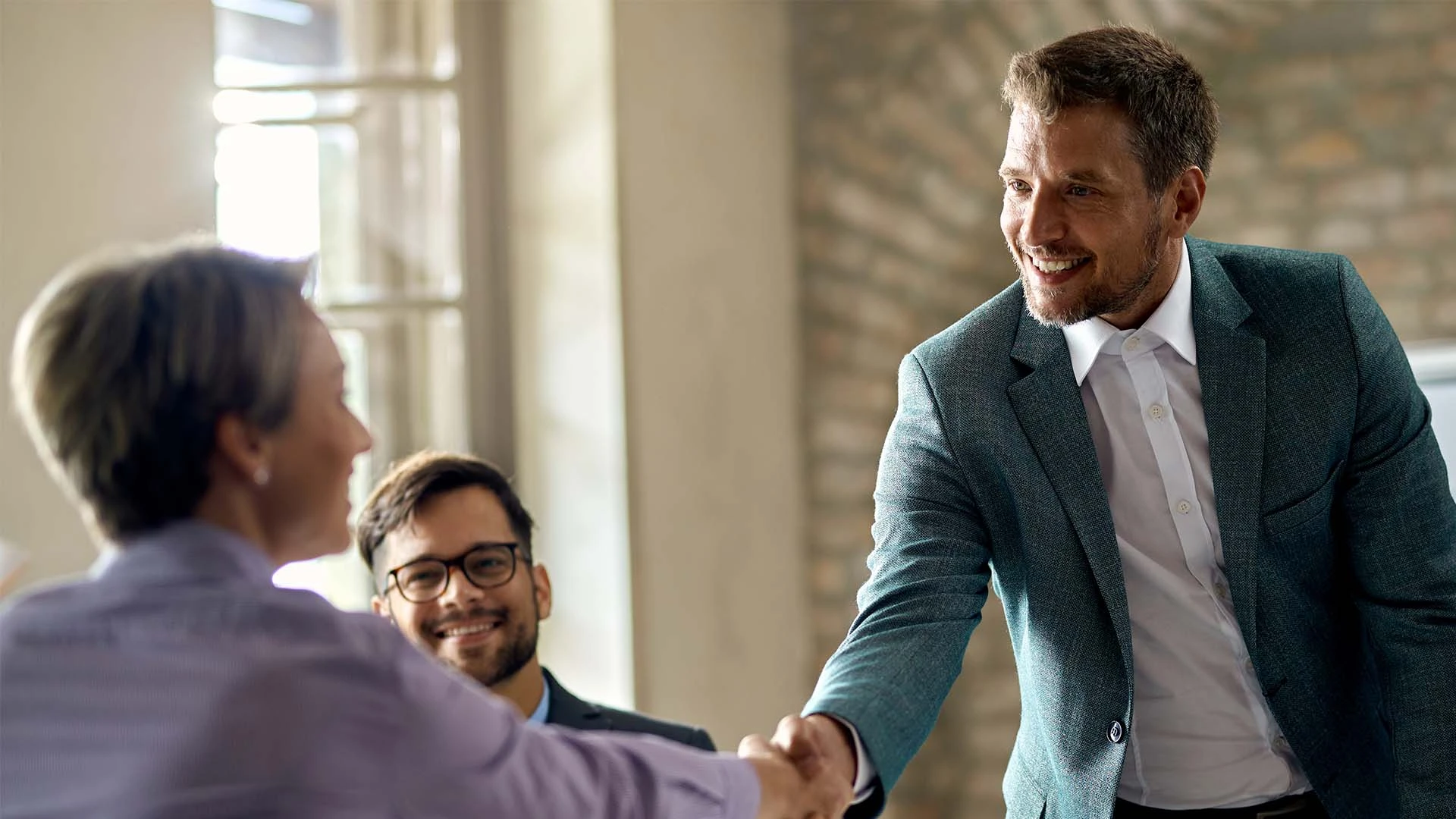 business-coworkers-shaking-hands-during-meeting-office-focus-is-businessman