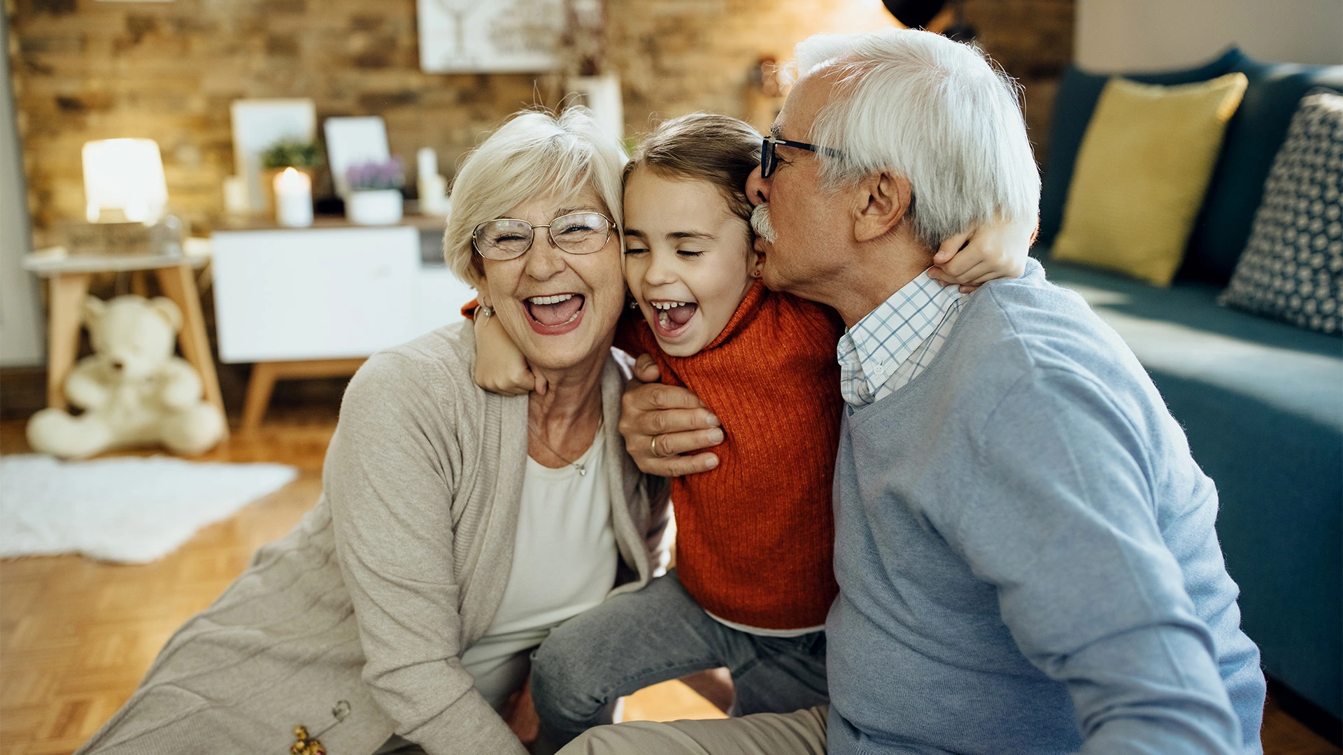 cheerful-grandparents-granddaughter-having-fun-together-home